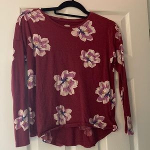 This is a cute maroon long sleeved shirt with flowers on it.